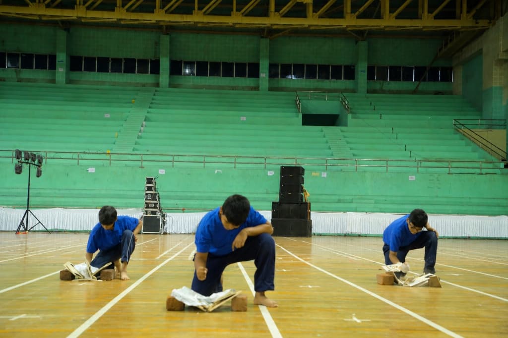 Students demonstrating board breaking during martial arts class